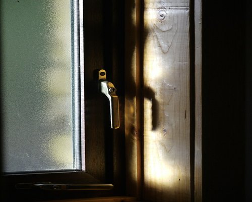 Sunlight reflecting strongly on a computer screen placed poorly near a window